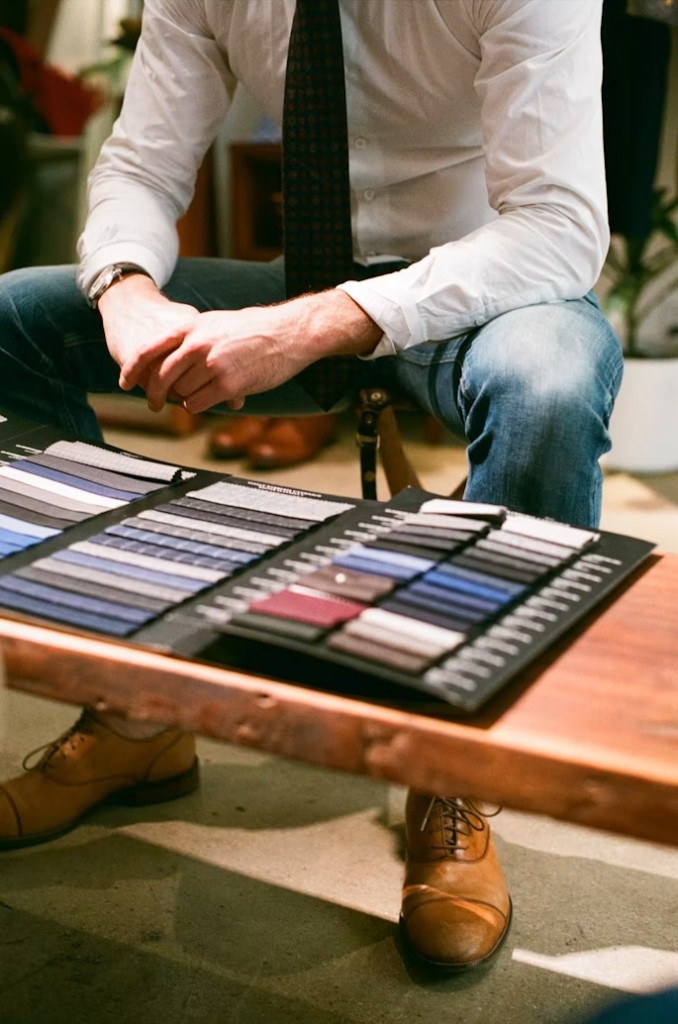 Client browsing fabric swatches at Perfect Attire